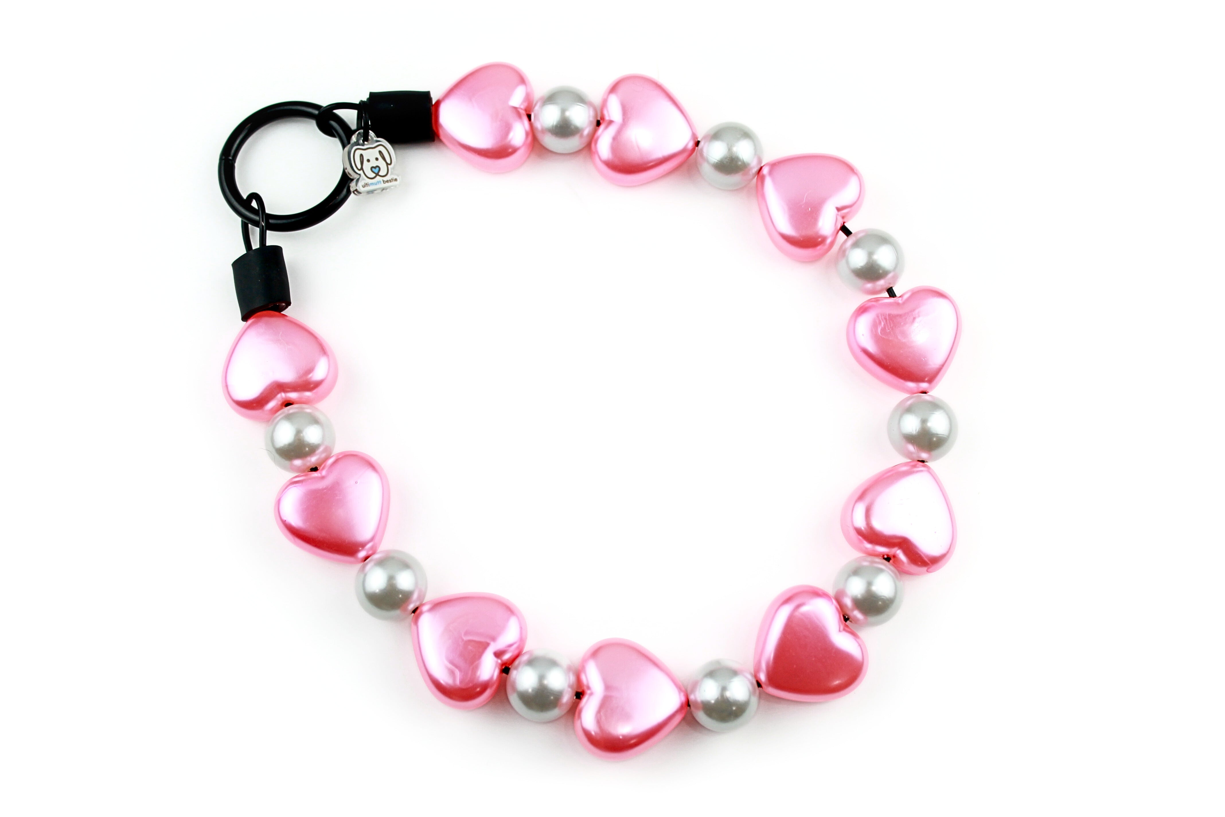 23mm acrylic large pink pearl hearts and smaller 16mm white pearl beads. The closure is a black o-ring, slip on over head style collar.