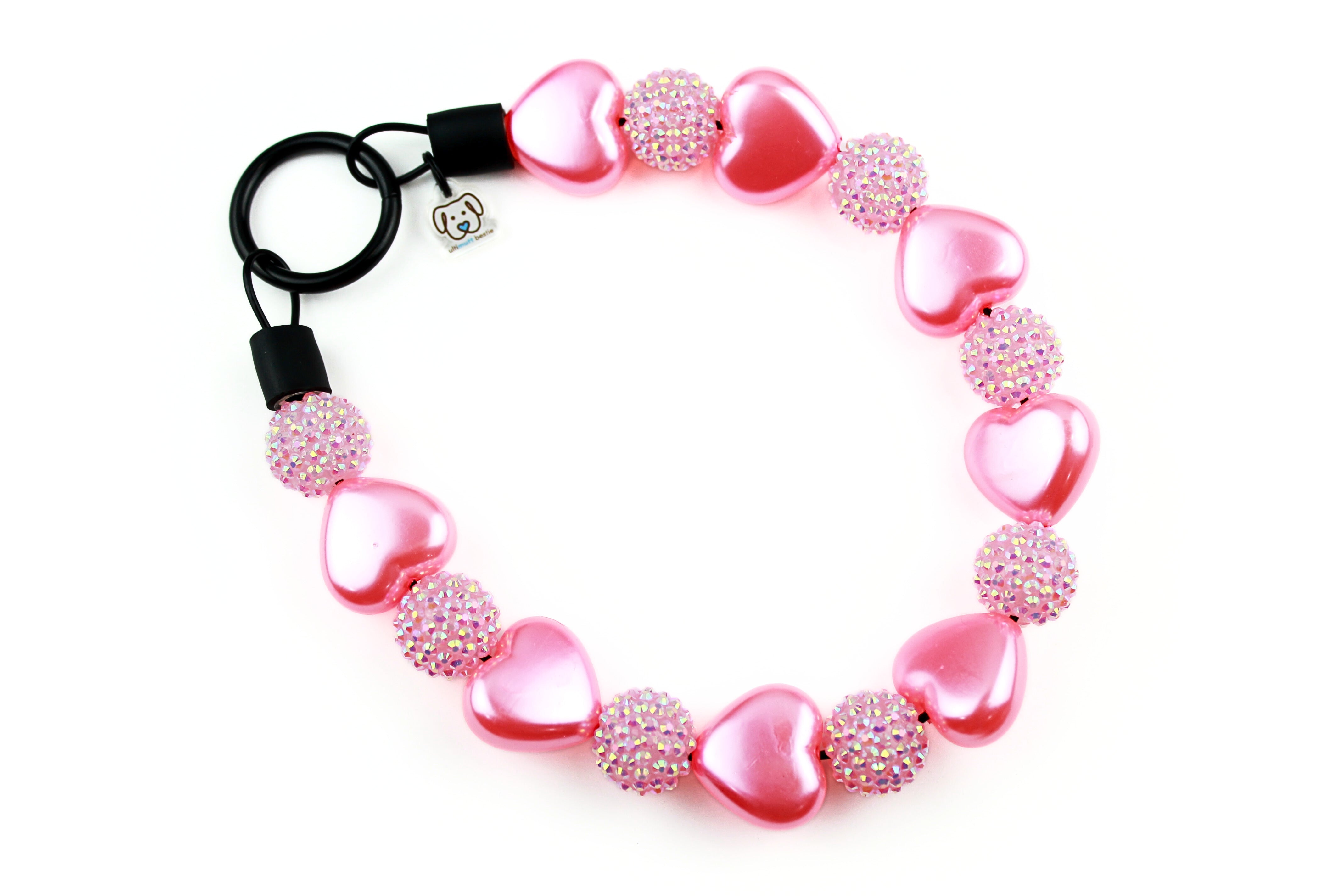 Large 23mm puffy pink pearl hearts with 20mm pink rhinestones with black o-ring closure. Slip on style