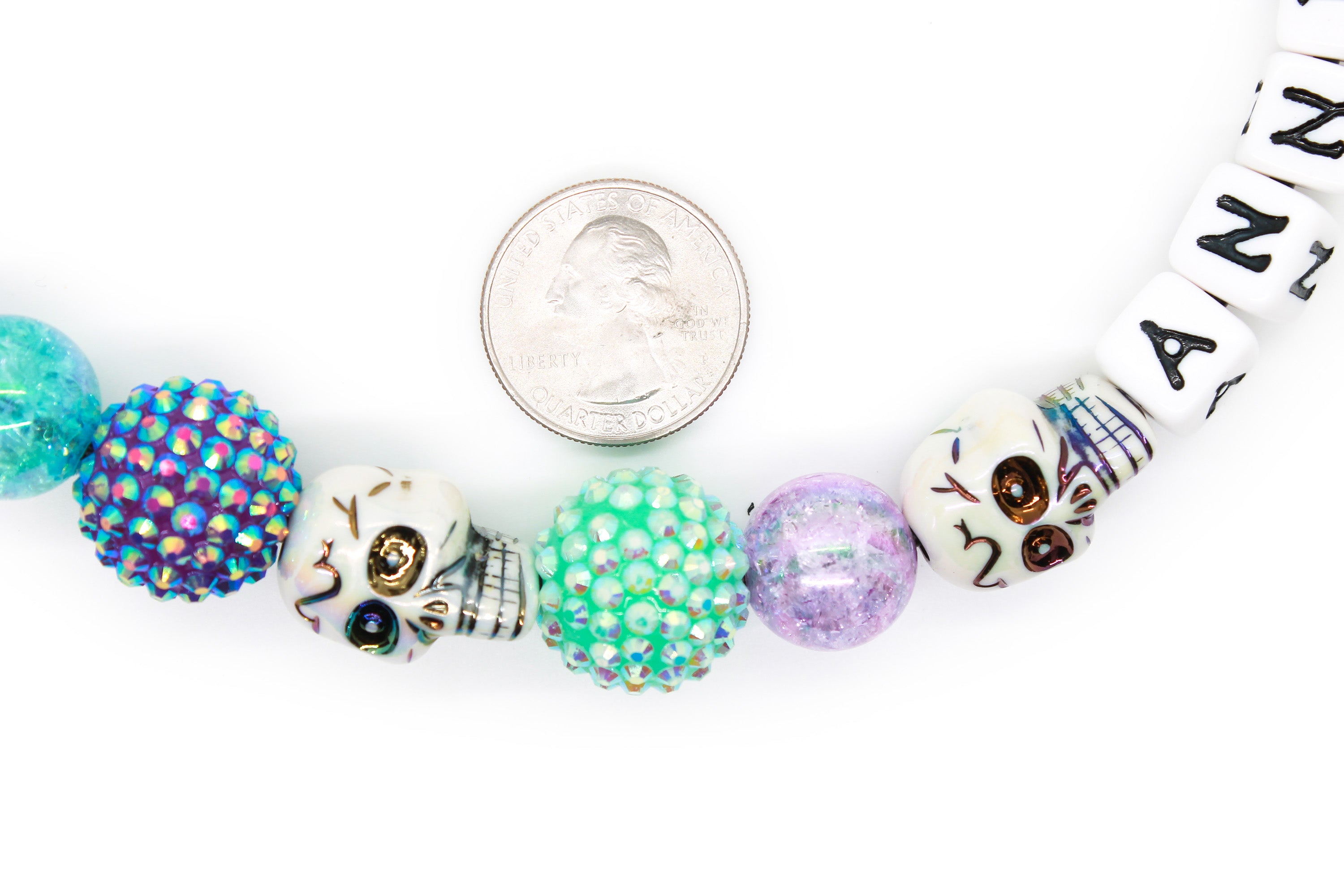 Close up of bead dog collar next to a quarter to show size of beads