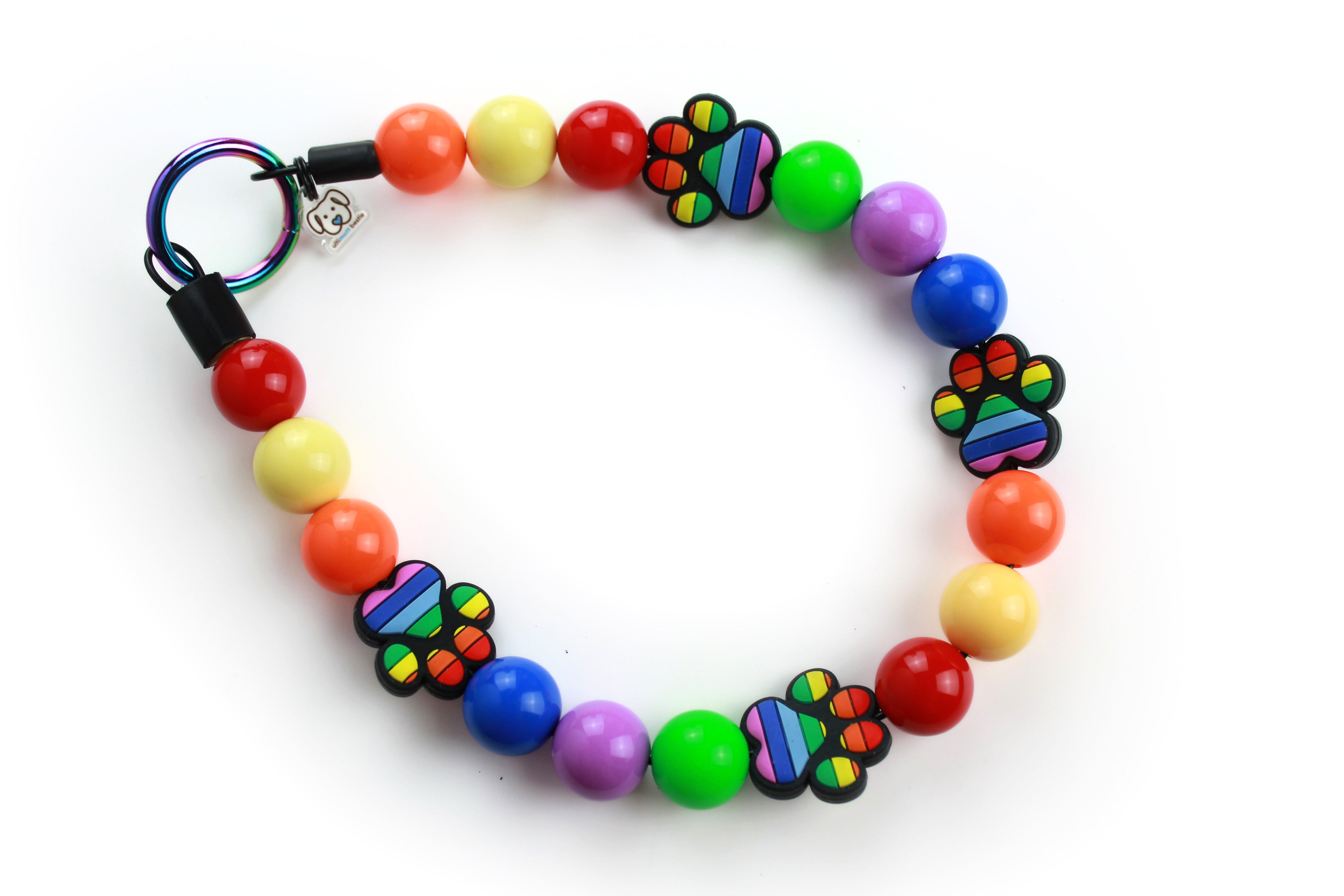 pride collar with array of rainbow solid beads and silicone stripped paw print focal beads